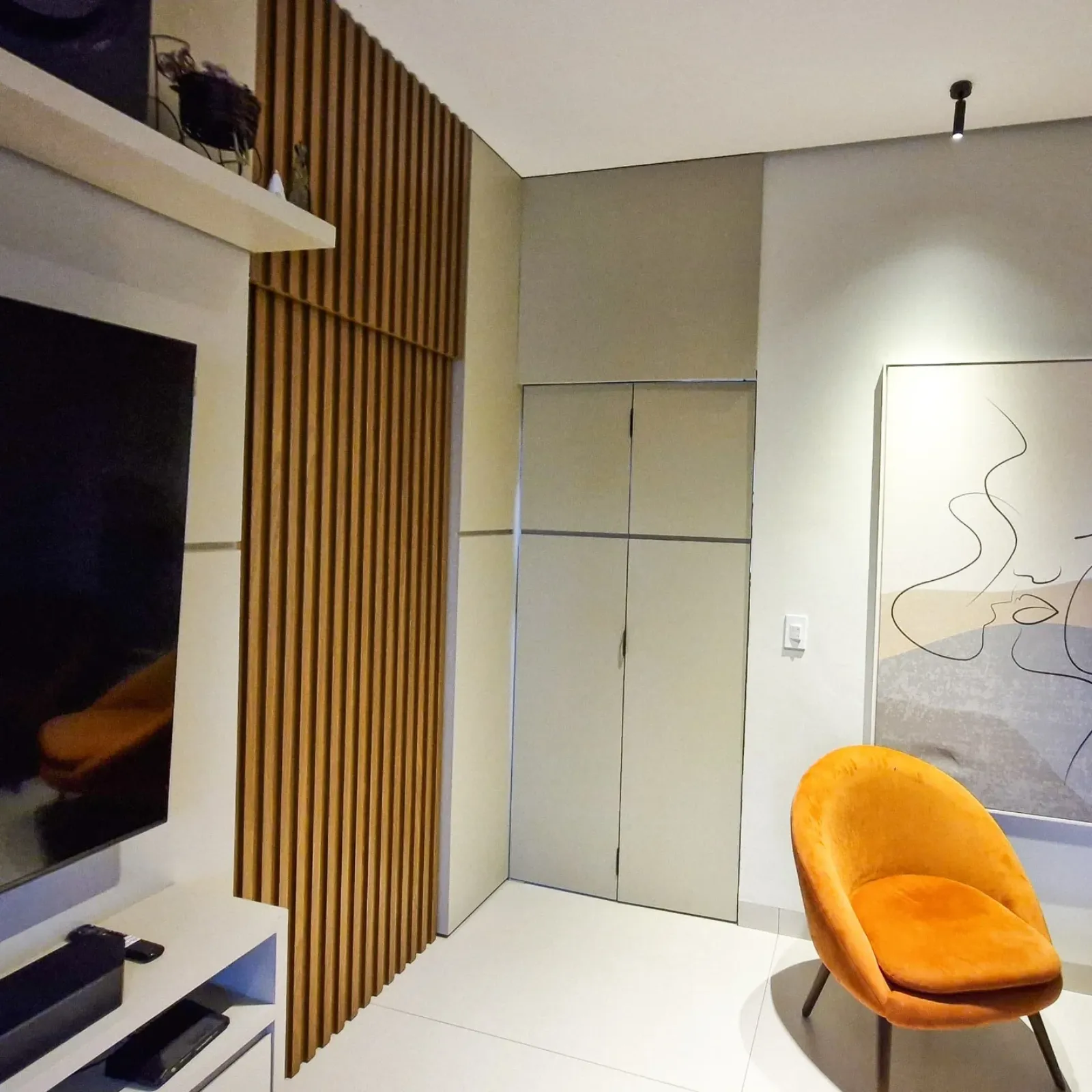 Sala planejada com painel ripado de madeira e armário sob medida em Primavera do Leste